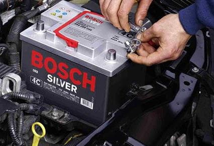 Our garage and workshop can make many fixes while you wait inclding new batteries and tyres Becra Auto Care fitting a new battery for a customer